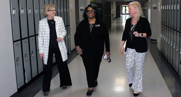 From left, Gray Stone administrator Helen Nance, Center for Safer School Executive Director Karen Fairley and Gray Stone middle school principal Pollyanne Rhodes share a lighthearted moment while walking through the halls of the middle school at Gray Stone. (Photo by Charles Curcio/staff)